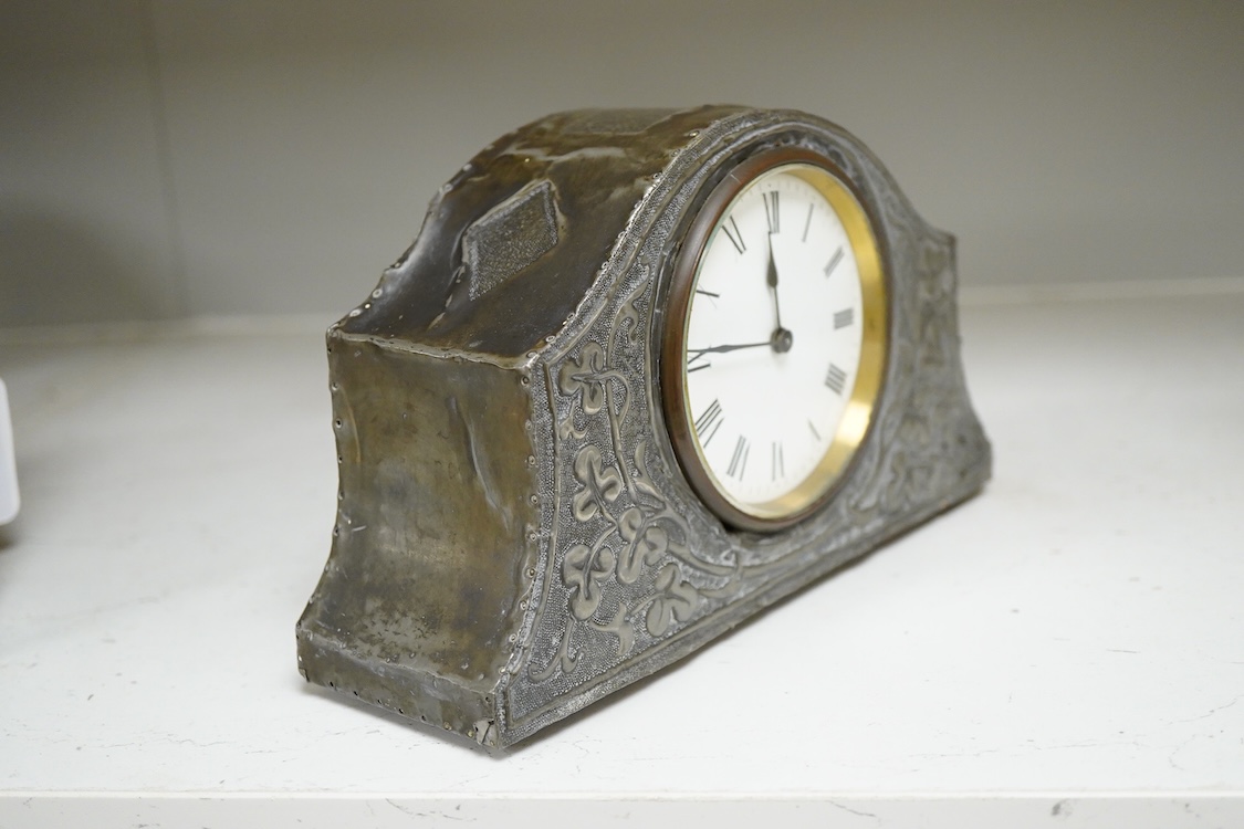 A pewter mantel timepiece with key, 22cm wide
